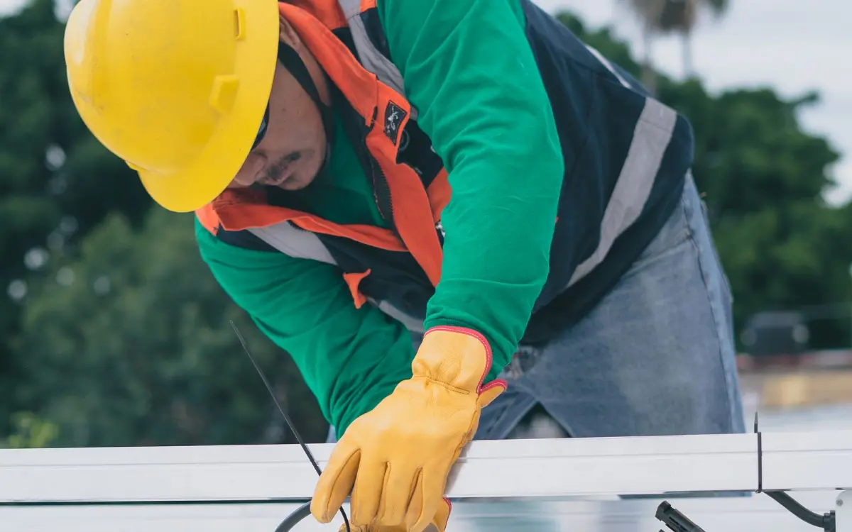 Crew member in a hard hat and harness on a power job