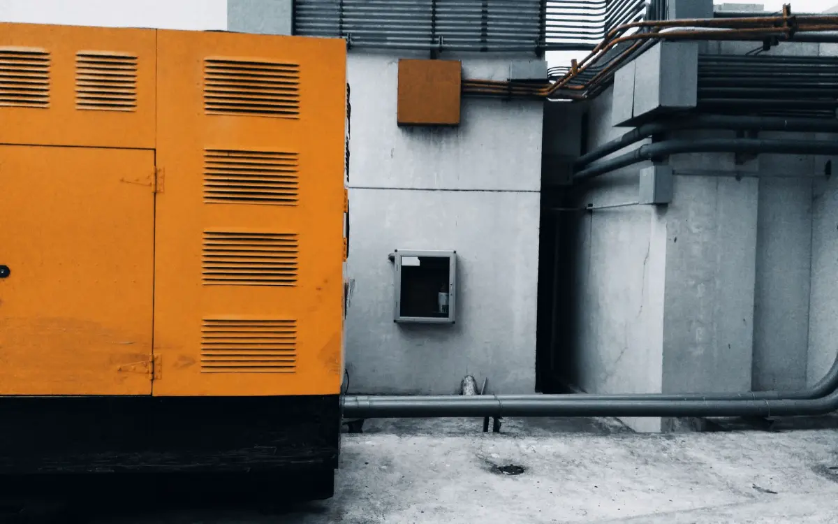 Commercial diesel generator enclosure beside a building