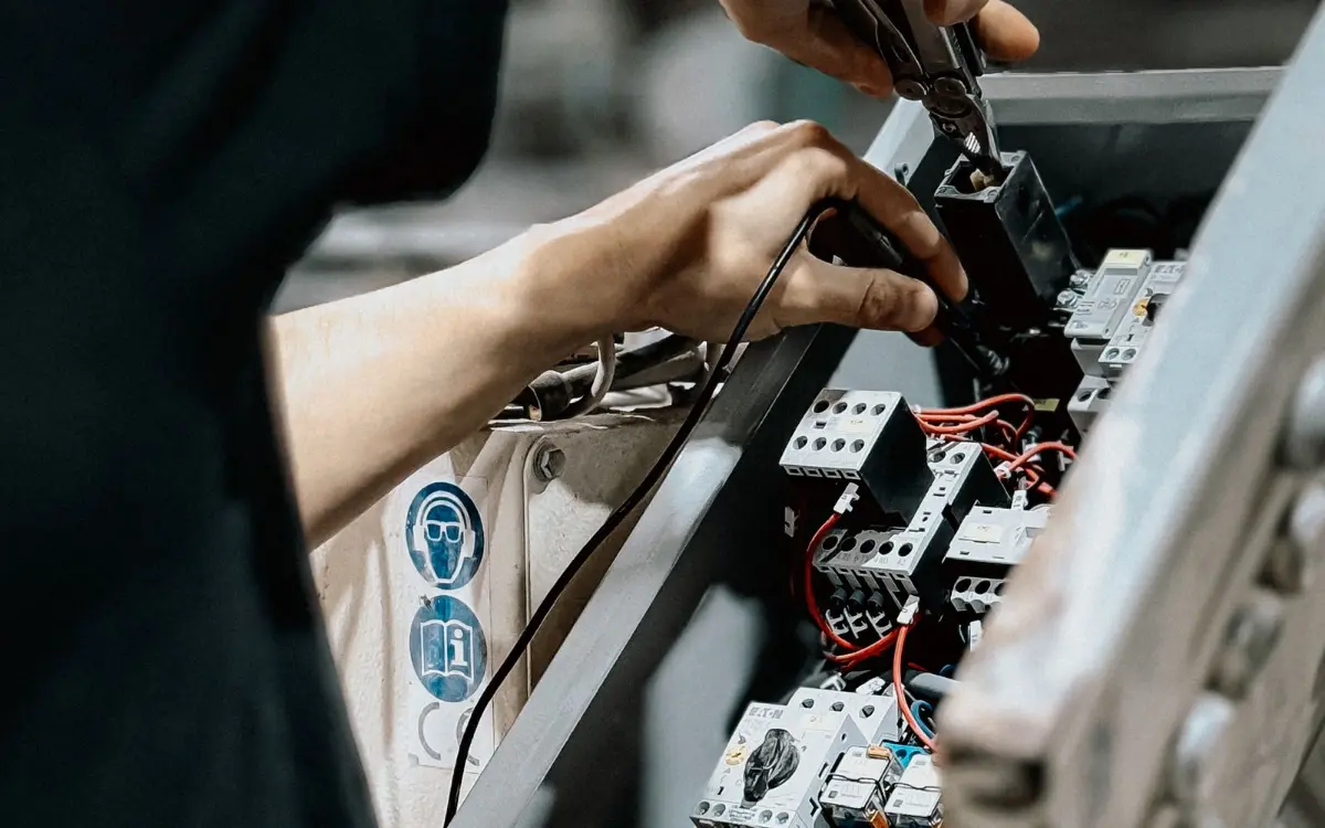 Hands wiring contactors inside a transfer switch panel
