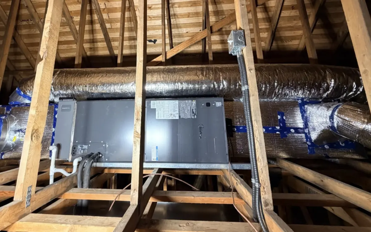 Air handler and ductwork in an attic, part of the heating load a generator has to carry